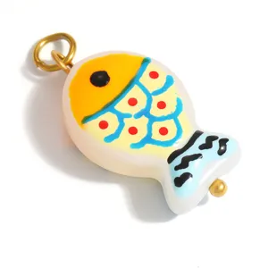 Close-up view of a vibrant colorful lampwork glass fish pendant for DIY jewelry making