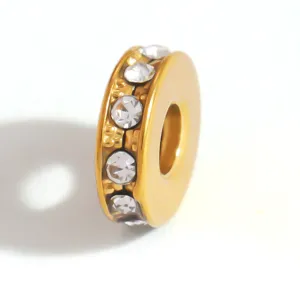 Detailed view of a gold-plated stainless steel spacer bead with sparkling crystals