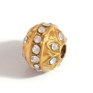 Macro view of gold-plated stainless steel jewelry spacer bead with clear rhinestone inlays