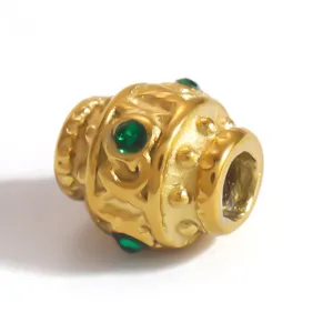 Close-up of gold-plated stainless steel barrel bead with green CZ inlay details