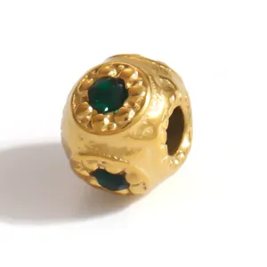 Close-up of gold-plated stainless steel spacer bead with green stone inlays