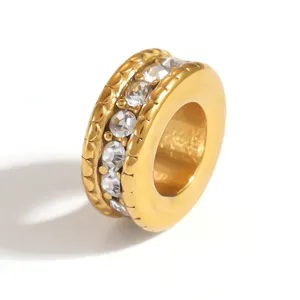 Detailed macro shot of a gold-plated stainless steel spacer bead with inlaid clear crystals