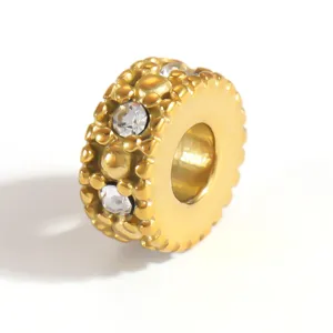 Macro view of gold-plated stainless steel spacer bead with sparkling inlaid clear crystals
