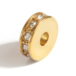 Detailed close-up of a gold-plated stainless steel spacer bead set with clear crystals