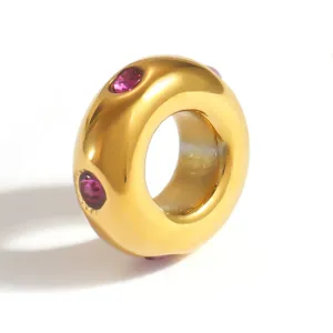 Close-up of gold plated stainless steel spacer bead with pink stones for DIY jewelry.