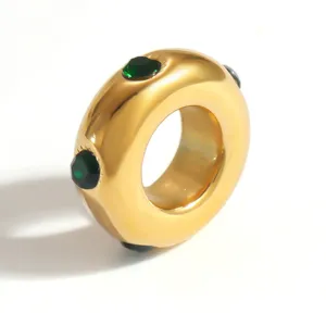 Close-up of a gold-plated stainless steel spacer bead featuring green faceted crystals.