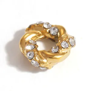 Detailed macro view of a gold-plated stainless steel spacer bead with inlaid crystals.