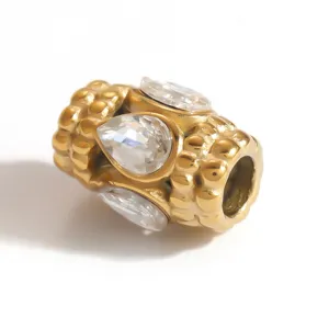 Detailed macro view of gold-plated stainless steel spacer bead with teardrop crystals