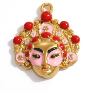 Detailed view of a gold-plated Peking Opera mask pendant with red enamel accents.