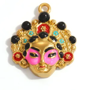 Close-up macro view of golden Peking Opera facial mask pendant with pink enamel details