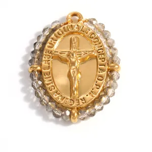 Detailed view of 18K gold plated crucifix pendant with smokey grey faceted beads.