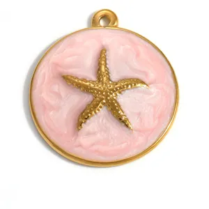Detail view of a gold plated starfish pendant with pink enamel for DIY jewelry making.