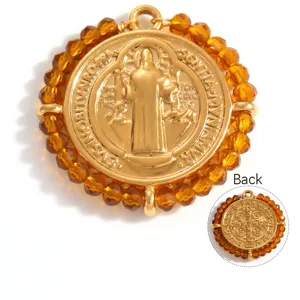 Detail view of both sides of a gold St. Benedict medal pendant with amber beads.