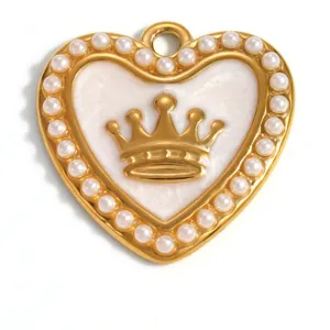 Detailed macro view of a gold-plated heart pendant featuring crown motif and pearl border