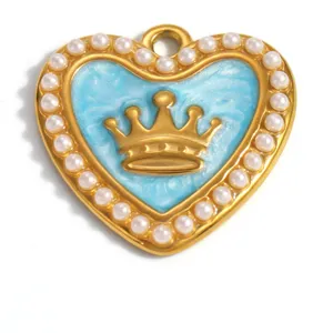 Close-up macro view of gold-plated heart pendant with blue enamel, crown and white pearls