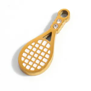 Detail shot of gold-plated titanium steel racket pendant with white enamel filling