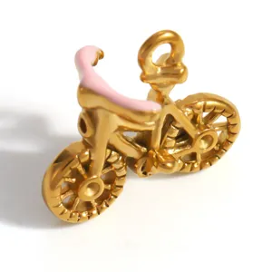 Detail of gold-plated bicycle charm pendant with pink enamel seat for jewelry making