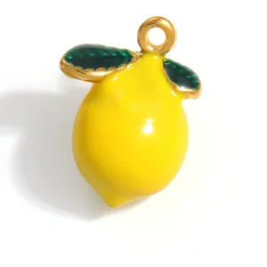 Close-up detail of a vibrant yellow enamel lemon pendant with green leaves and gold ring