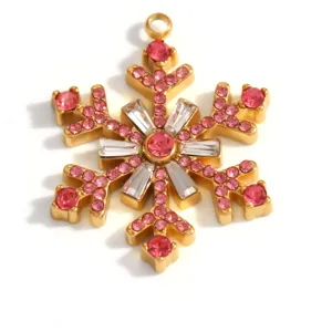 Detailed view of the gold-plated snowflake pendant with sparkling pink rhinestones
