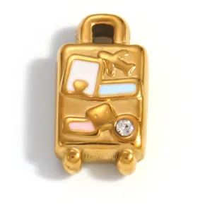Detailed view of a gold-plated titanium steel suitcase charm with crystal