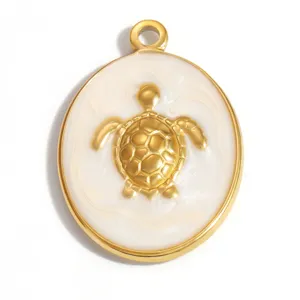 Detailed view of a gold-plated stainless steel sea turtle pendant with white marbled enamel