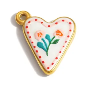 Close-up of heart-shaped stainless steel charm with hand-painted floral enamel detail