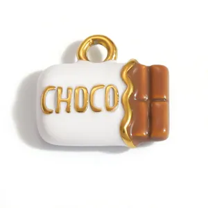 Macro view of a chocolate-shaped stainless steel jewelry charm with CHOCO lettering