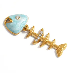 Close-up of gold stainless steel fishbone pendant with blue enamel rose pattern