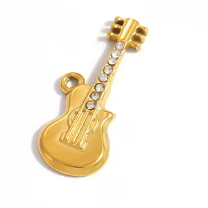 Macro view showing details of golden stainless steel guitar charm with rhinestone inlay