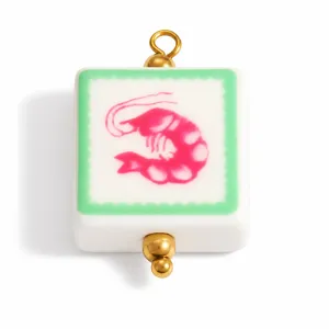 Close-up of a square enamel pendant with a pink shrimp and green wavy border