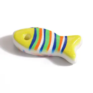 Detailed view of a colorful fish-shaped stainless steel bead for DIY jewelry making.