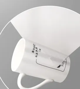 White ceramic coffee mug featuring custom printed sticker label with minimalist black text.