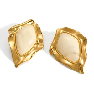 Detailed view of vintage irregular geometric gold plated stainless steel earrings with resin