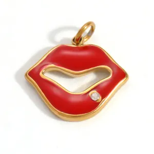 Macro view of gold-plated red enamel lip pendant with sparkling inset crystal detail