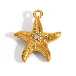 Macro view of a gold-plated stainless steel starfish pendant featuring a clear crystal
