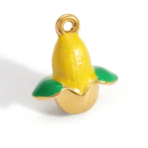 Detailed macro view of a yellow and green enamel fruit pendant with gold plating