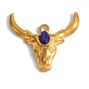 Detail of a gold-plated bull head pendant with an inlaid blue gemstone centerpiece.