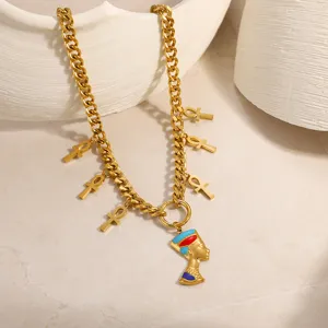 Close-up of gold plated Egyptian Queen pendant and Ankh charms on a Cuban chain