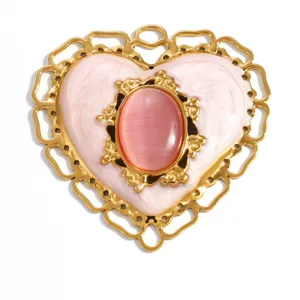 Détail de près du pendentif cœur vintage avec pierre œil de chat rose et huile d'émail