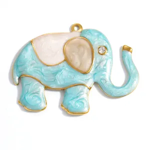 Macro view of gold-plated elephant pendant with light blue enamel and crystal eye detail