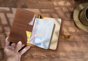 Detailed close-up view of vintage genuine leather passport holder with slots and notebook.