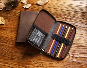 Detail shot of the vintage genuine leather pencil case, showing elastic pen slots and mesh pocket.