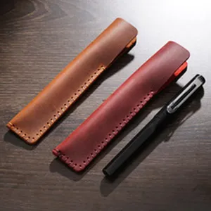 Handmade leather pen sleeve detail showing exquisite stitching and vintage texture design.