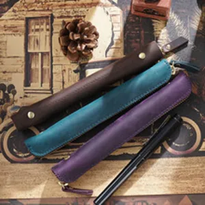 Detail view of handmade genuine leather pen sleeve, retro style stationery organizer.
