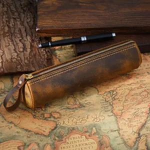 Detailed view of handmade retro genuine leather pencil case, vintage style stationery holder.