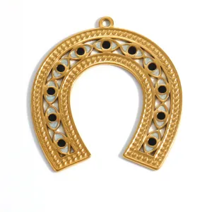 Detailed macro view of gold-plated horseshoe pendant with multi-evil eye motifs