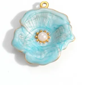 Close-up macro view of a light blue enamel flower pendant accessory with pearl center