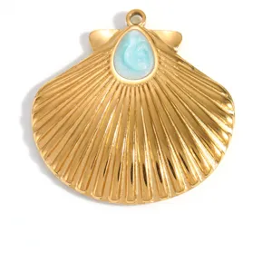 Detail view of a gold-plated stainless steel shell pendant with blue teardrop resin.