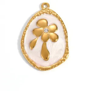 Macro view of gold-plated stainless steel flower pendant with white enamel finish