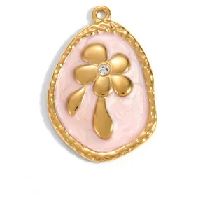 Close-up of gold-plated pendant with pink enamel and a crystal flower design